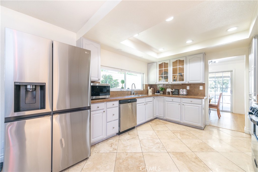 23711 Silver Spray Drive Diamond Bar, CA 91765 - Photo 20 of 49 a kitchen with stainless steel appliances granite countertop a refrigerator and a stove top oven