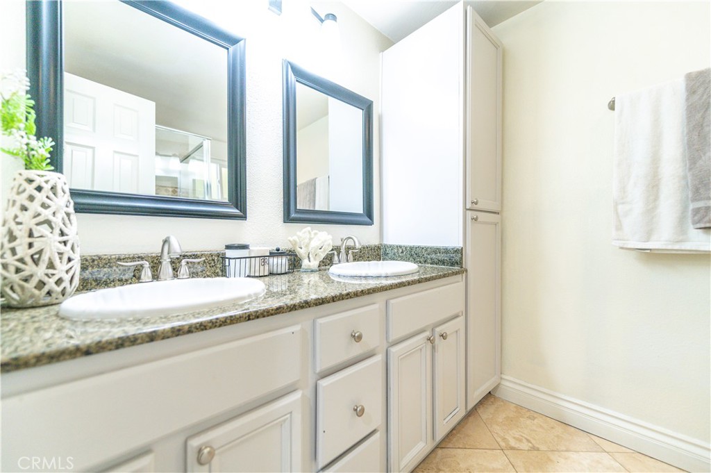 23711 Silver Spray Drive Diamond Bar, CA 91765 - Photo 28 of 49 a bathroom with a granite countertop sink and a mirror