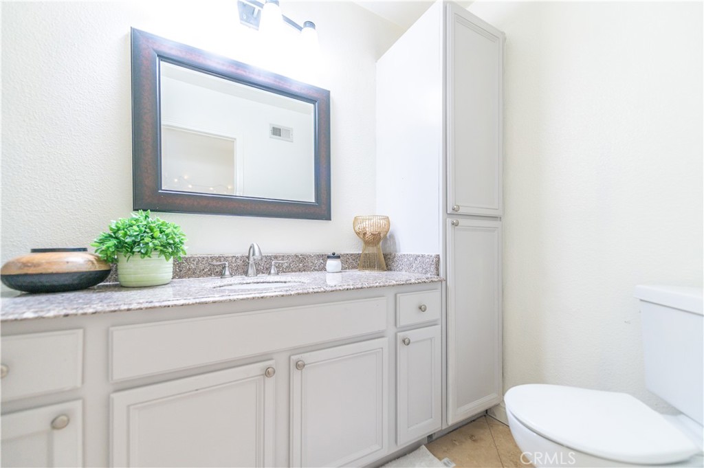 23711 Silver Spray Drive Diamond Bar, CA 91765 - Photo 31 of 49 a bathroom with a toilet a sink and mirror