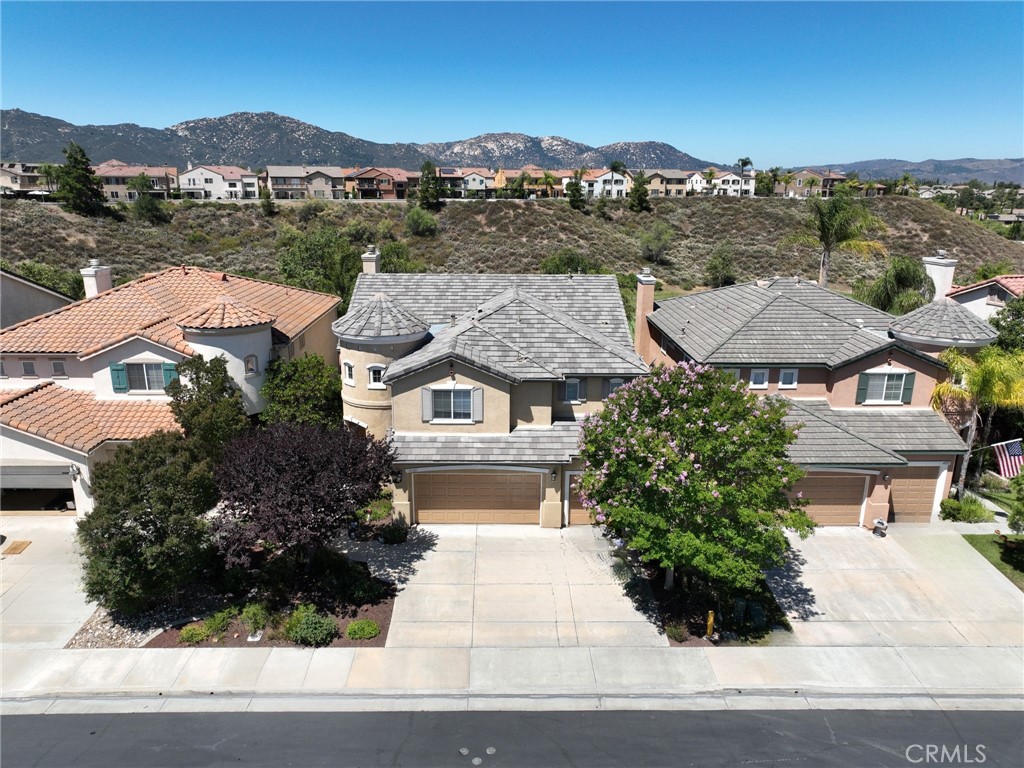 an aerial view of houses with a street