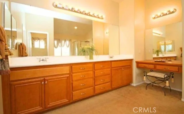 a spacious bathroom with a double vanity sink a mirror and a bathtub