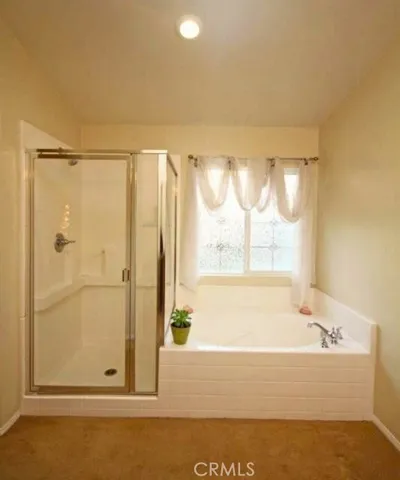 a bathroom with a bathtub and shower