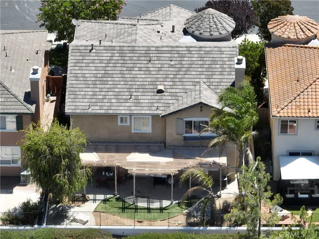 a view of house with yard and outdoor seating