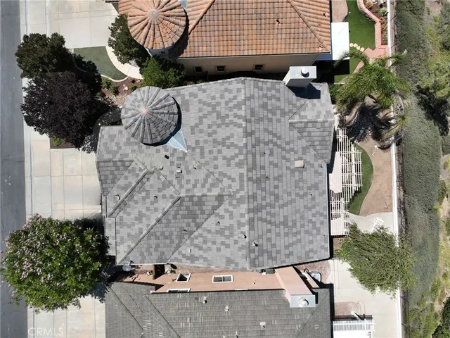 an aerial view of a house with a yard