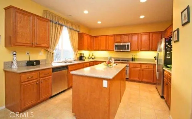 a kitchen with stainless steel appliances granite countertop a sink and a stove