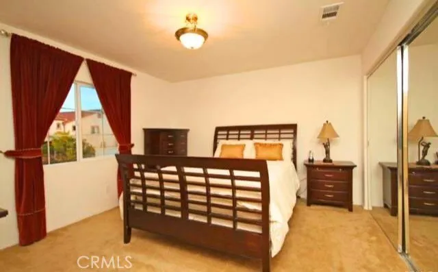 a bedroom with a bed and a window