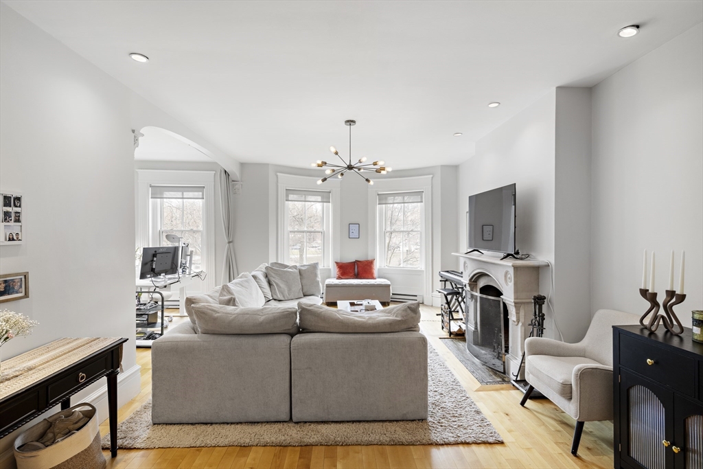 427 Shawmut Avenue, Unit 3 Boston, MA 02118 - Photo 12 of 26 a living room with furniture a fireplace and a flat screen tv