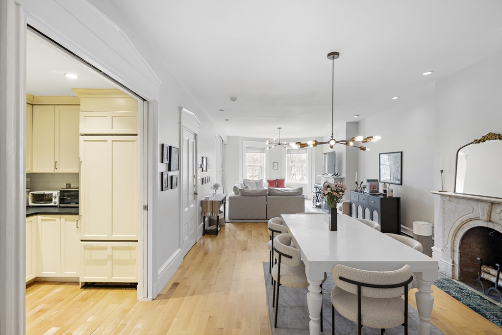 427 Shawmut Avenue, Unit 3 Boston, MA 02118 - Photo 14 of 26 a large kitchen with a table chairs refrigerator and cabinets
