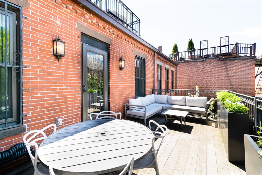 427 Shawmut Avenue, Unit 3 Boston, MA 02118 - Photo 22 of 26 a view of a dinning tables and chairs in patio
