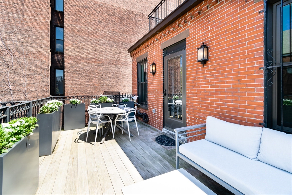 427 Shawmut Avenue, Unit 3 Boston, MA 02118 - Photo 23 of 26 a balcony with furniture and wooden floor