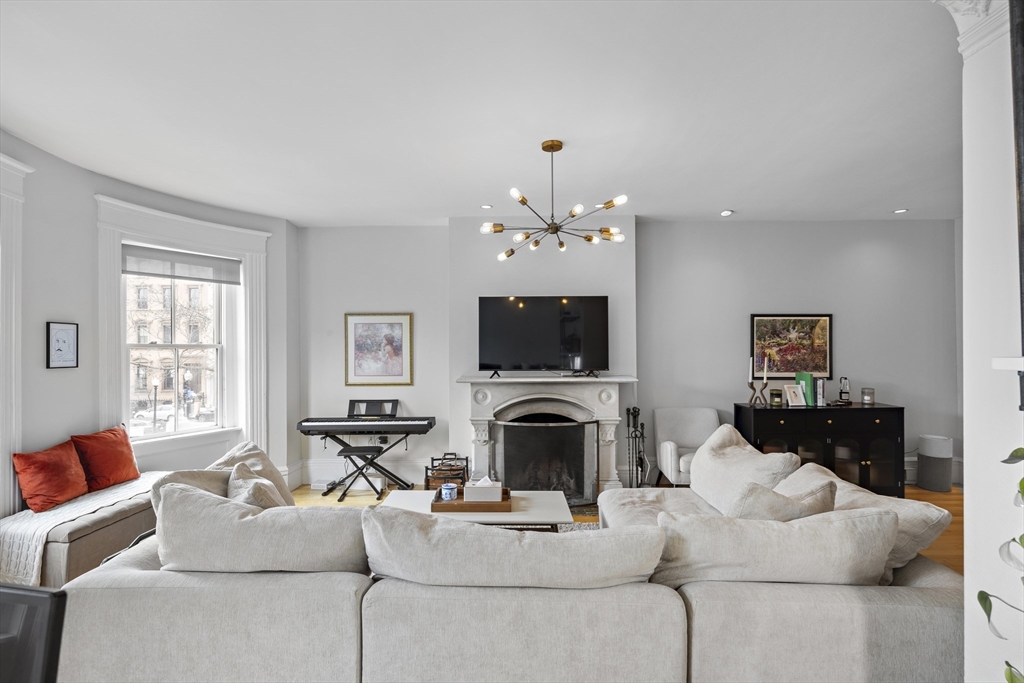 427 Shawmut Avenue, Unit 3 Boston, MA 02118 - Photo 5 of 26 a living room with furniture a flat screen tv and a window