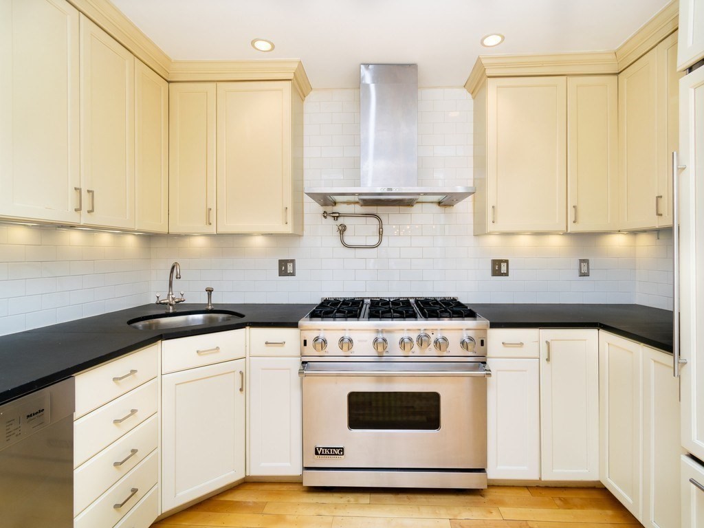 427 Shawmut Avenue, Unit 3 Boston, MA 02118 - Photo 9 of 26 a kitchen with granite countertop white cabinets and white appliances