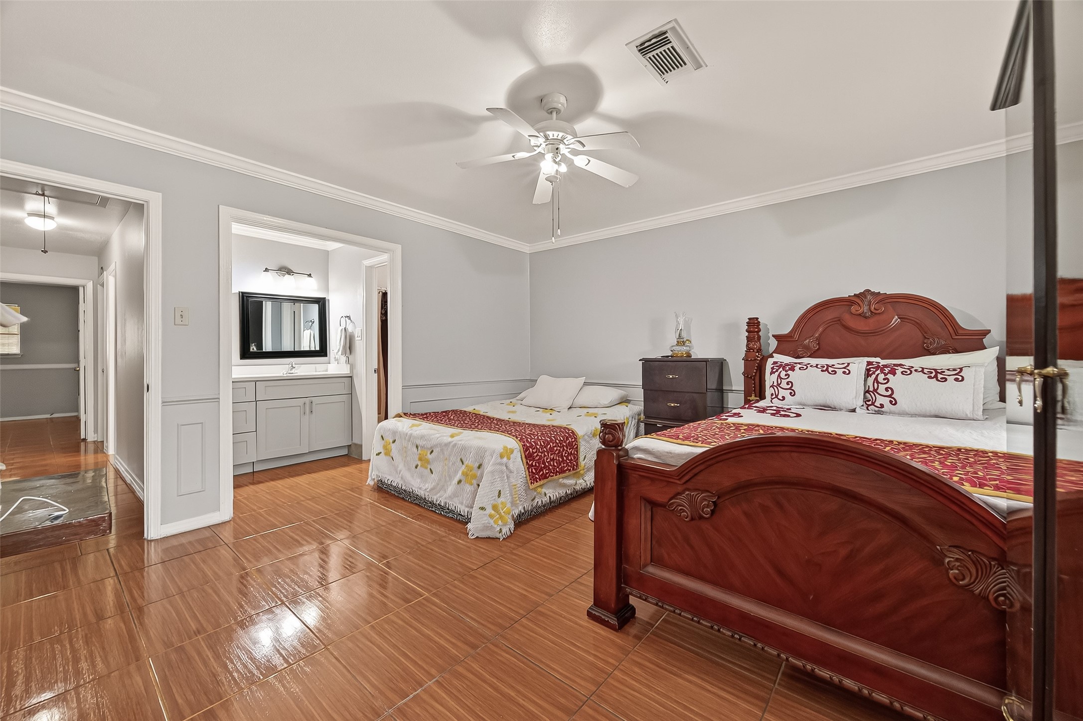 9030 Troulon Drive Houston, TX 77036 - Photo 17 of 34 Large primary bedroom with convenient direct access to a private en-suite bathroom featuring a modern vanity.