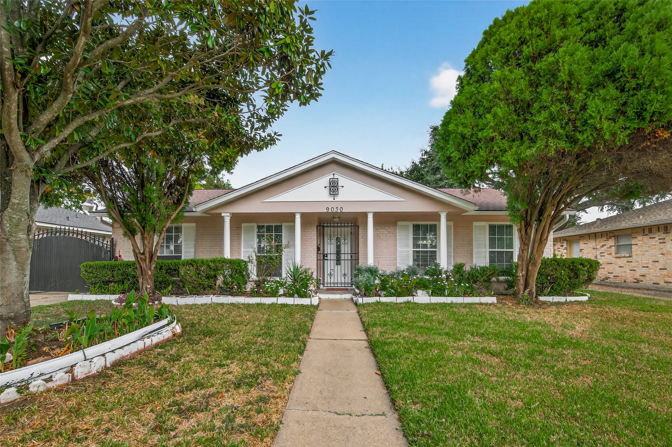 9030 Troulon Drive Houston, TX 77036 - Photo 2 of 34 Charming single-story home with a manicured lawn, inviting front walkway, and mature trees offering excellent curb appeal.