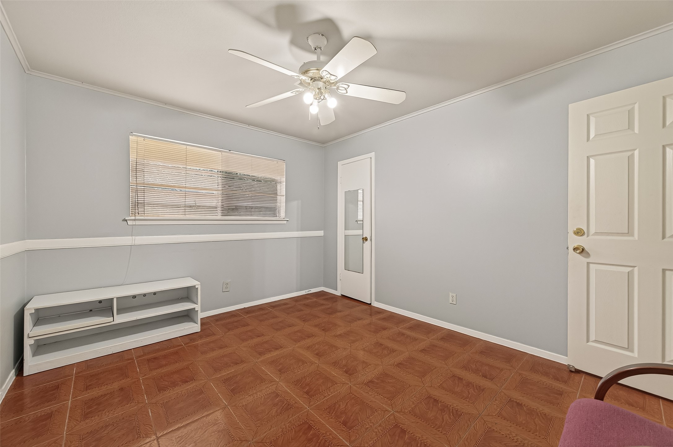 9030 Troulon Drive Houston, TX 77036 - Photo 21 of 34 Inviting room with tile flooring, a refreshing ceiling fan, and multiple windows/doors providing versatility and brightness.