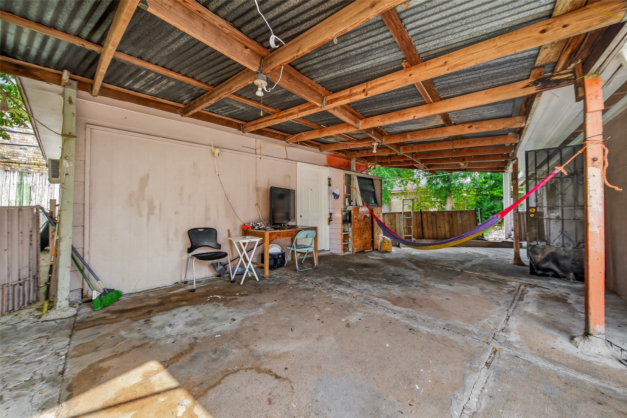 9030 Troulon Drive Houston, TX 77036 - Photo 26 of 34 Versatile covered patio space offering a relaxed atmosphere with a hammock, ready for outdoor furniture and enjoyment.