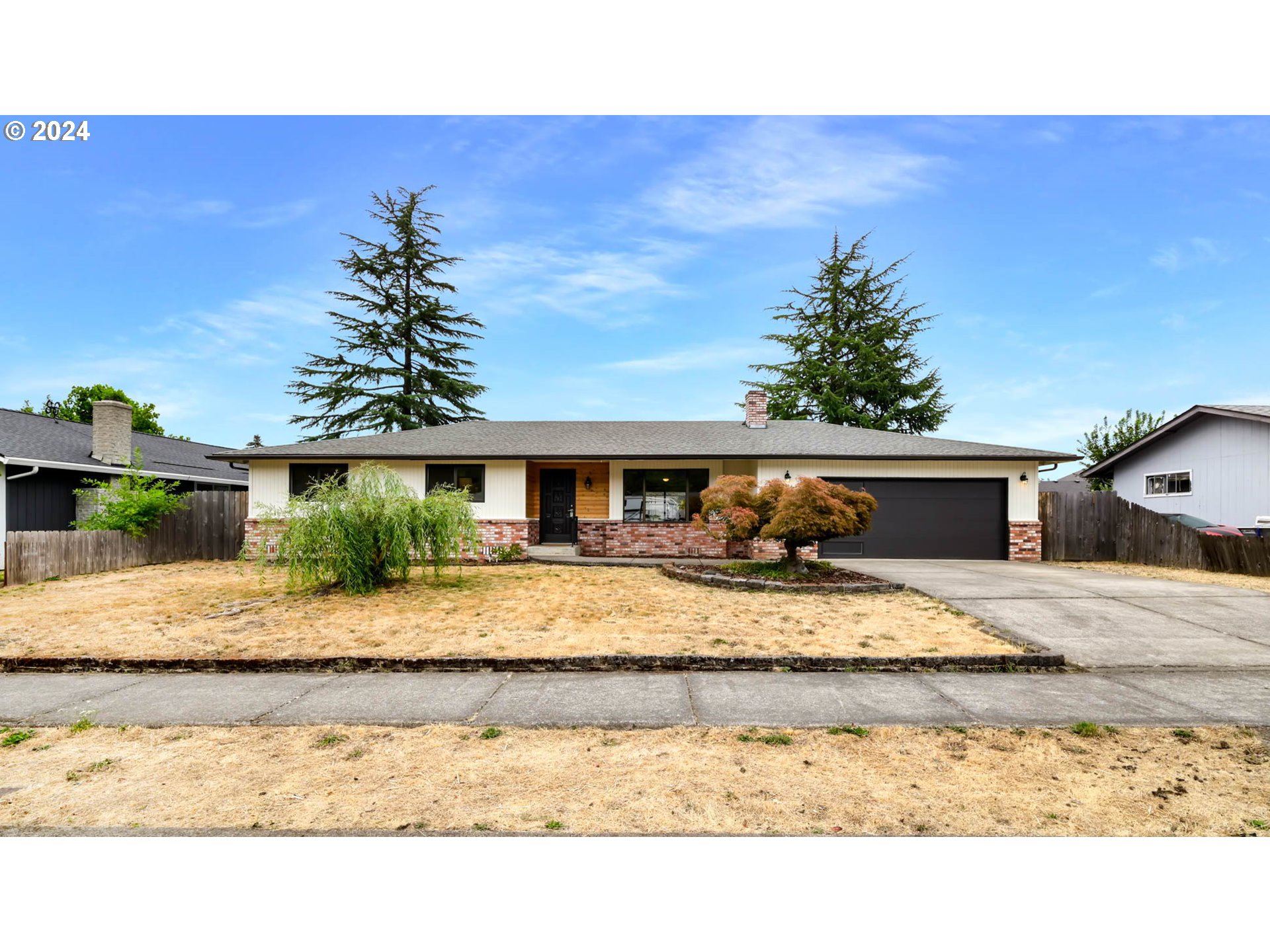7136 B Street Springfield, OR 97478 - Photo 1 of 46 a front view of a house with a yard