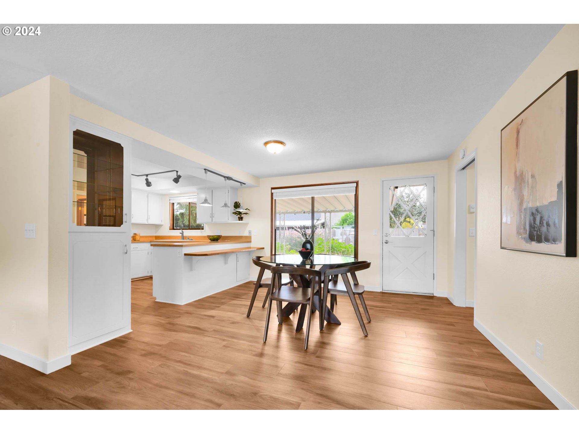 7136 B Street Springfield, OR 97478 - Photo 12 of 46 a dining room with furniture a large window and wooden floor