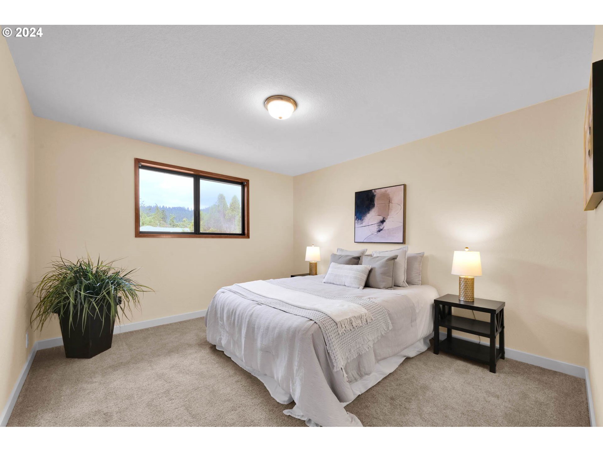 7136 B Street Springfield, OR 97478 - Photo 22 of 46 a bedroom with a bed and a potted plant