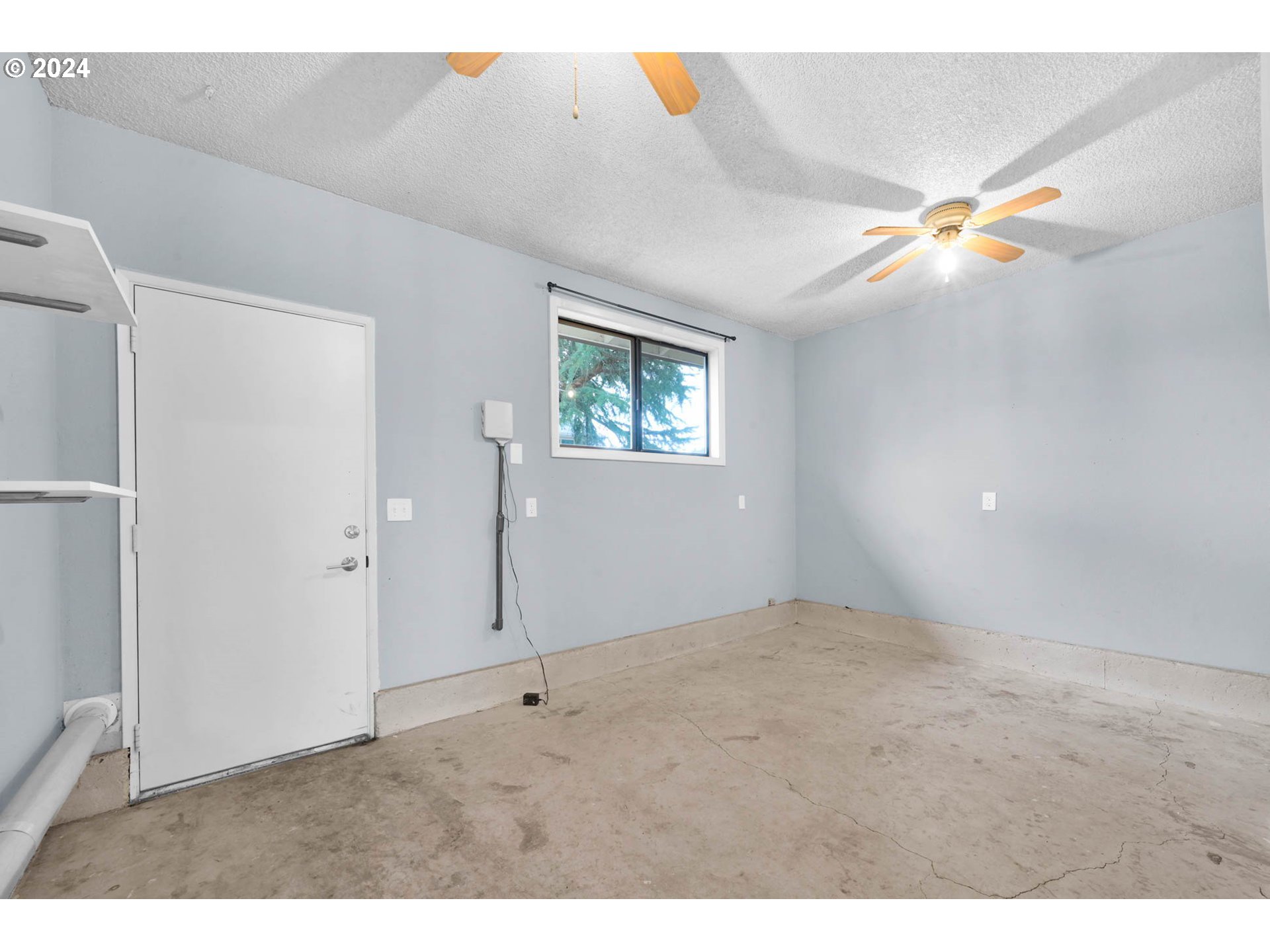 7136 B Street Springfield, OR 97478 - Photo 39 of 46 a view of an empty room with window and chandelier fan