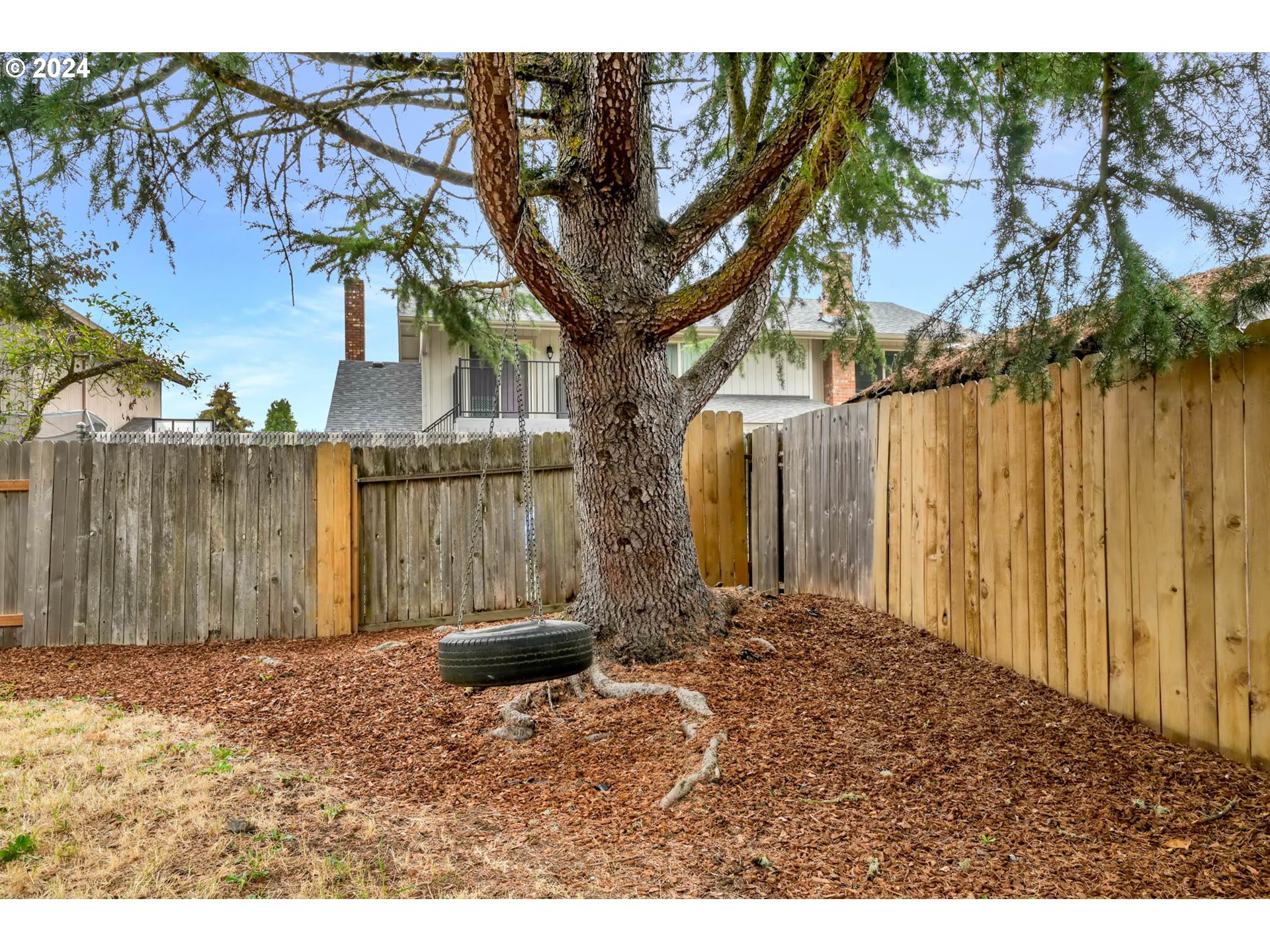 7136 B Street Springfield, OR 97478 - Photo 44 of 46 a backyard of a house with a bench and trees
