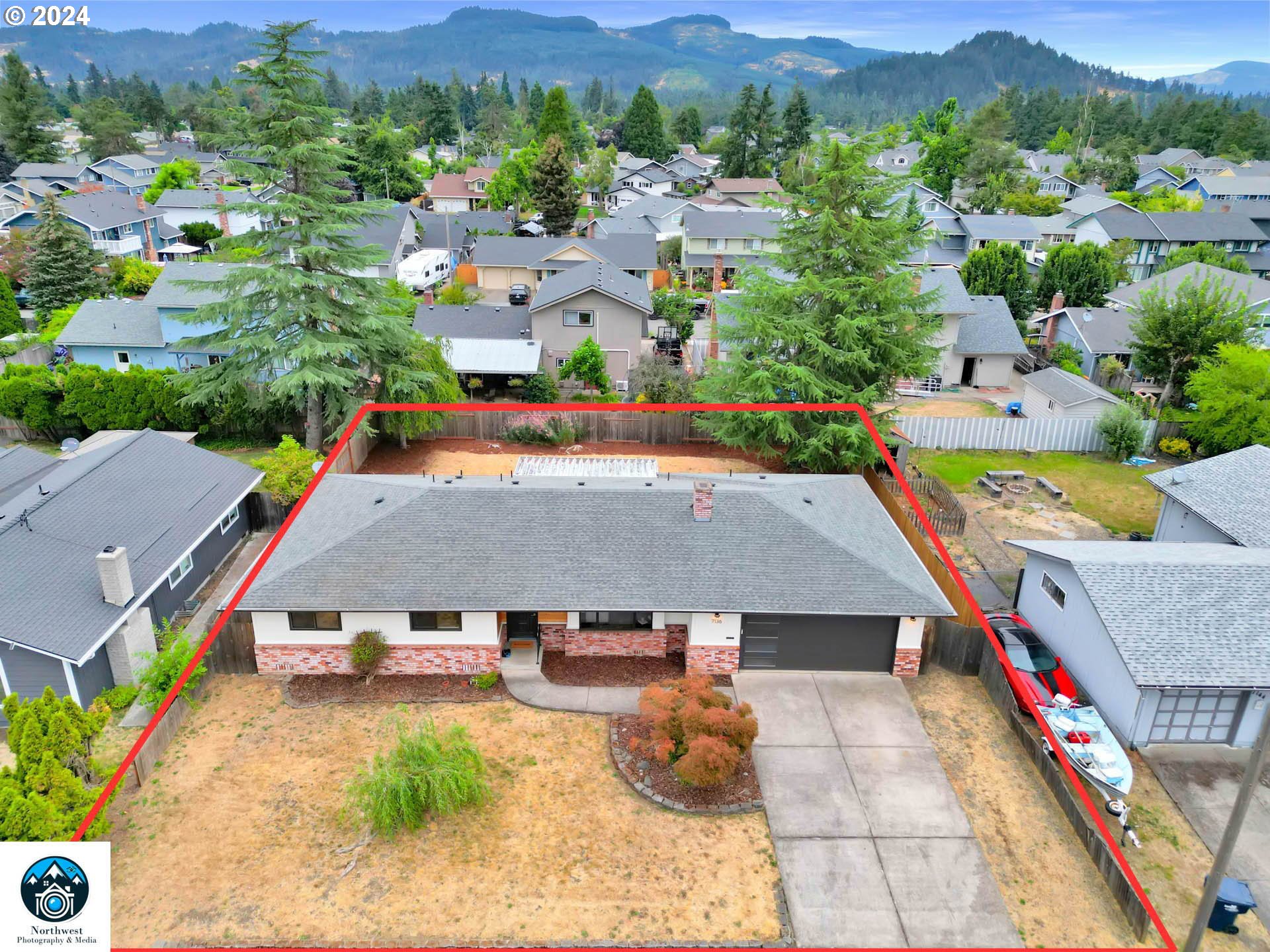 7136 B Street Springfield, OR 97478 - Photo 5 of 46 an aerial view of a house with swimming pool and mountain view