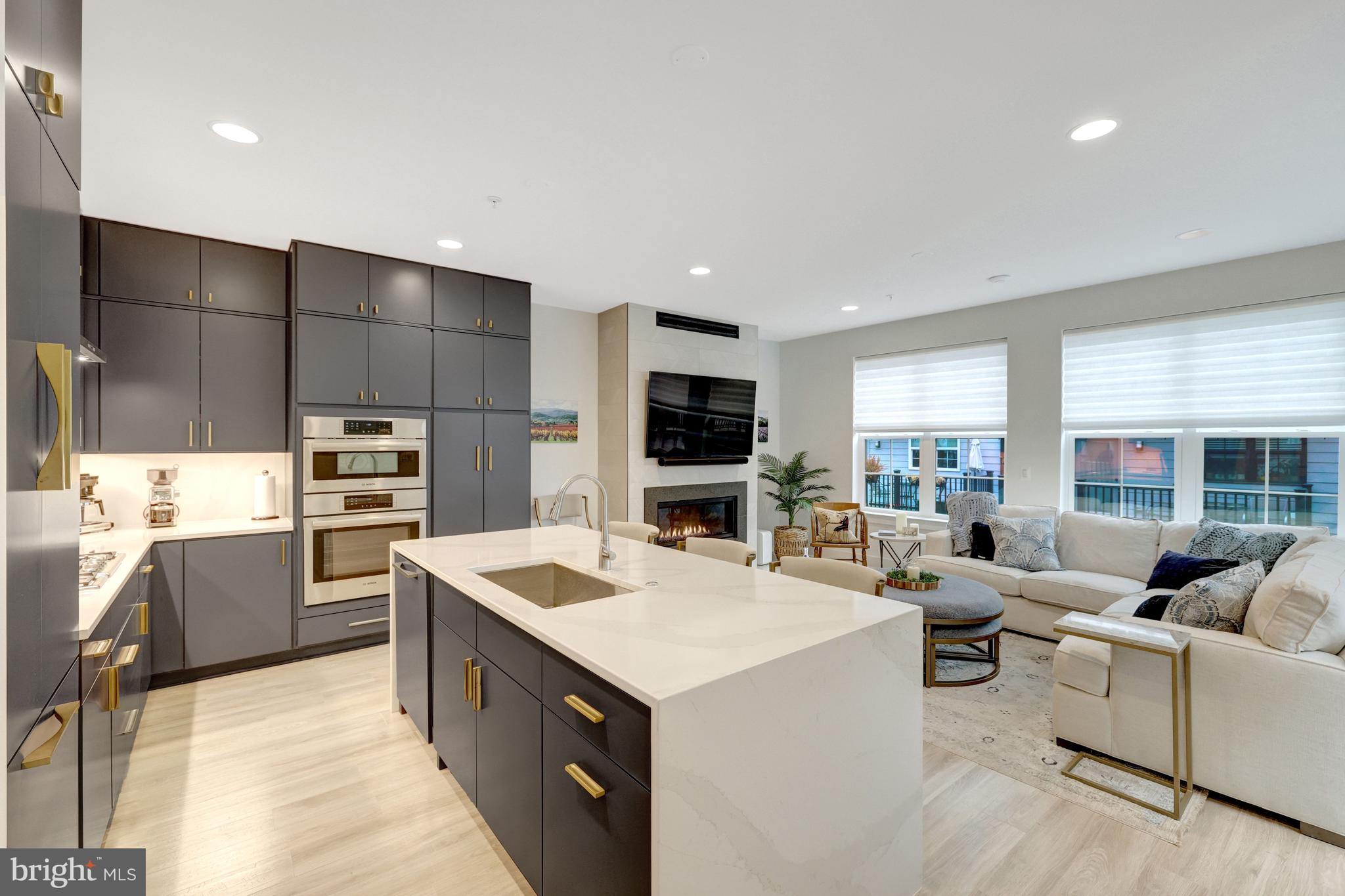 11236 Faraday Park Drive Reston, VA 20190 - Photo 13 of 74 a view of kitchen with stainless steel appliances kitchen island a sink dishwasher a stove and a refrigerator with wooden floor