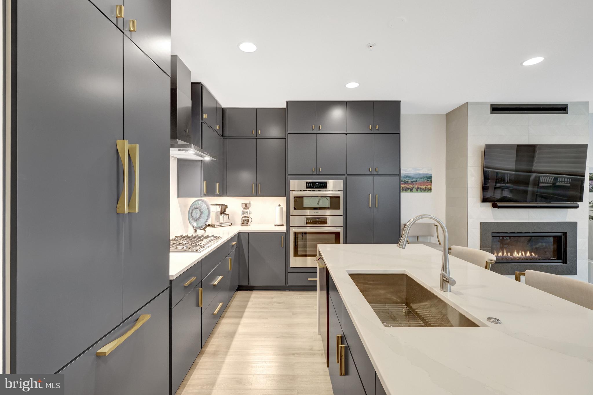 11236 Faraday Park Drive Reston, VA 20190 - Photo 14 of 74 a kitchen with granite countertop a refrigerator and a stove top oven