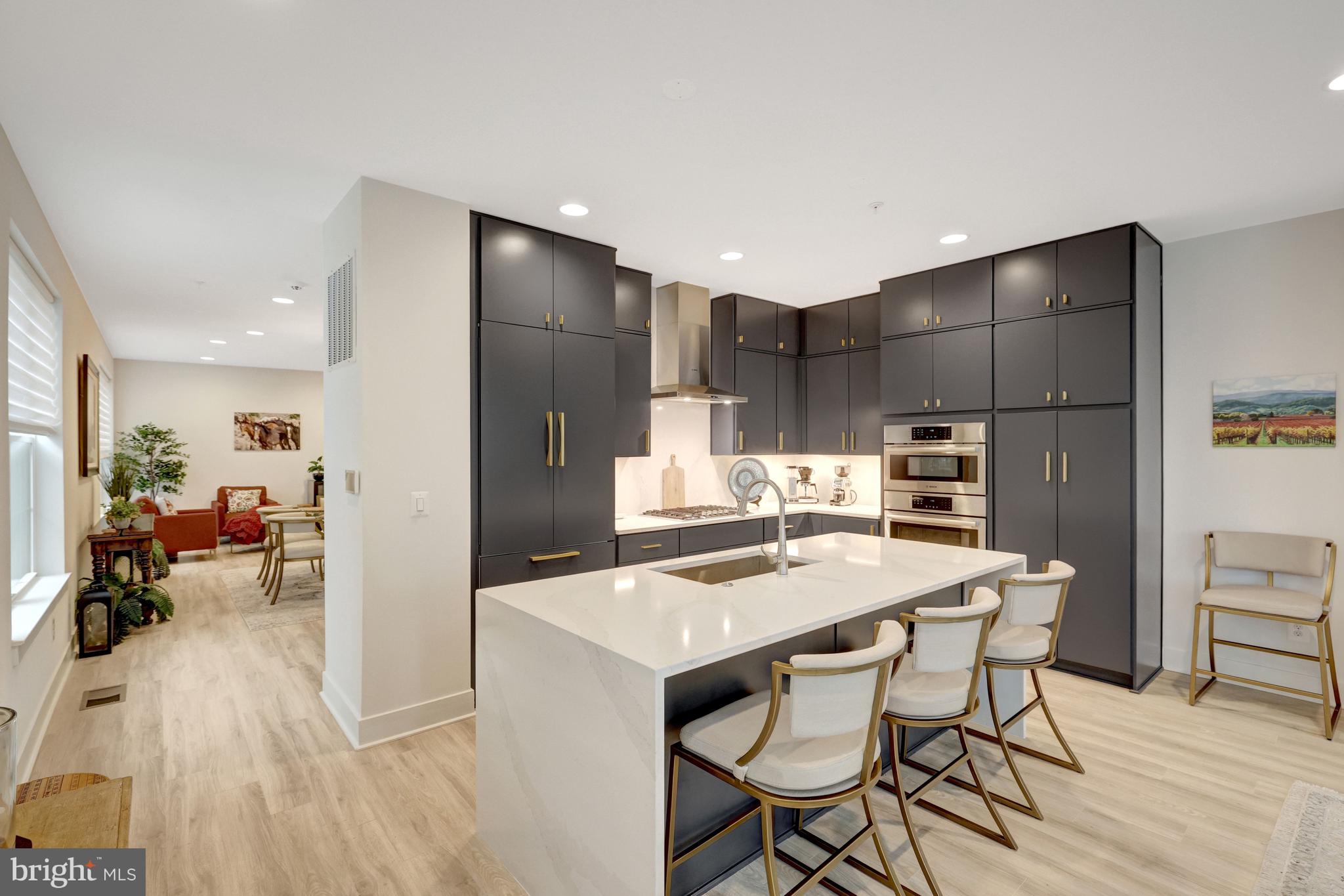 11236 Faraday Park Drive Reston, VA 20190 - Photo 15 of 74 a kitchen with kitchen island a stove a table and chairs