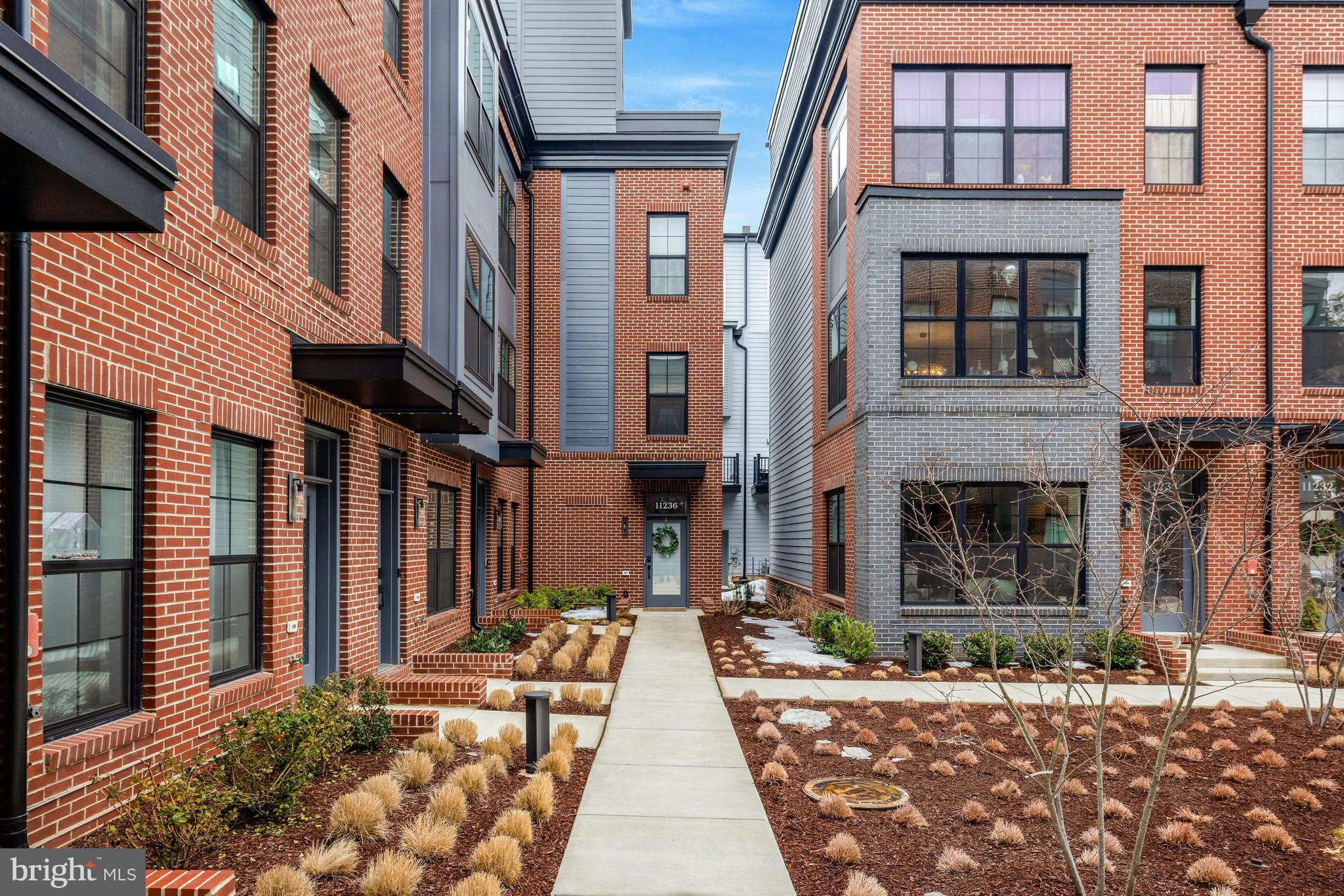 11236 Faraday Park Drive Reston, VA 20190 - Photo 2 of 74 a view of a brick building with many windows