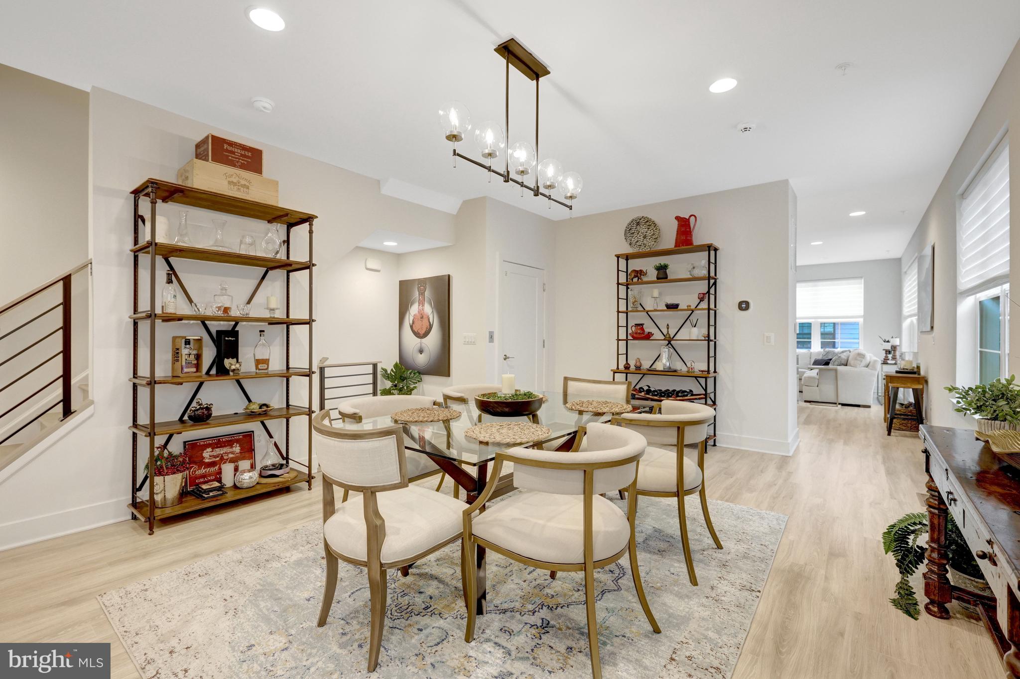 11236 Faraday Park Drive Reston, VA 20190 - Photo 23 of 74 a view of a livingroom and a dining room with furniture wooden floor and a chandelier