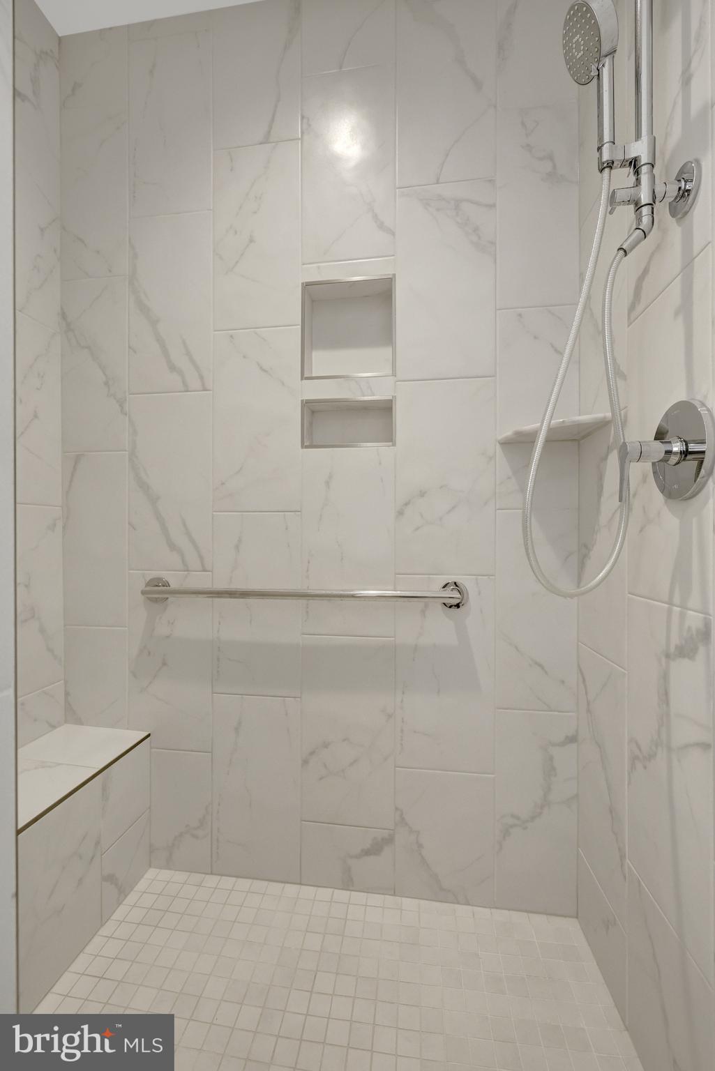 11236 Faraday Park Drive Reston, VA 20190 - Photo 37 of 74 The primary bathroom shower has a built-in bench.