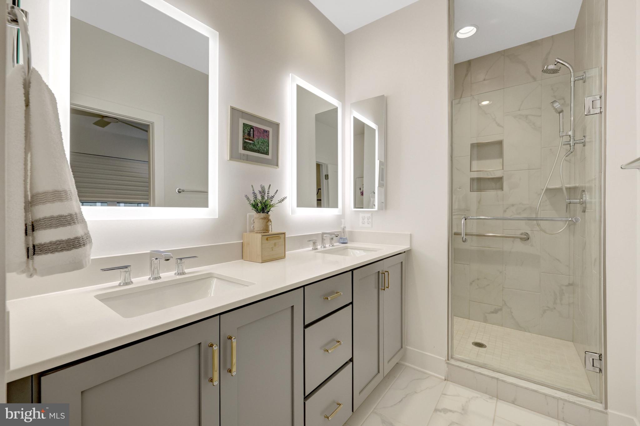 11236 Faraday Park Drive Reston, VA 20190 - Photo 37 of 74 a bathroom with a shower sink and mirror