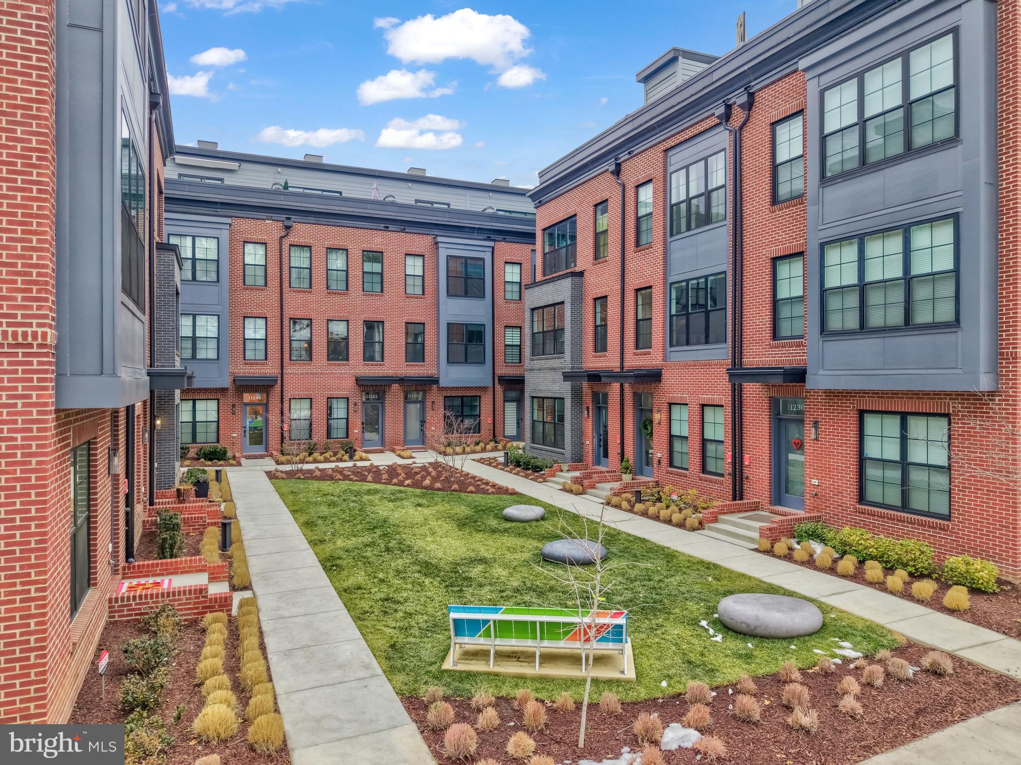 11236 Faraday Park Drive Reston, VA 20190 - Photo 62 of 74 A view of the open space and sidewalks.