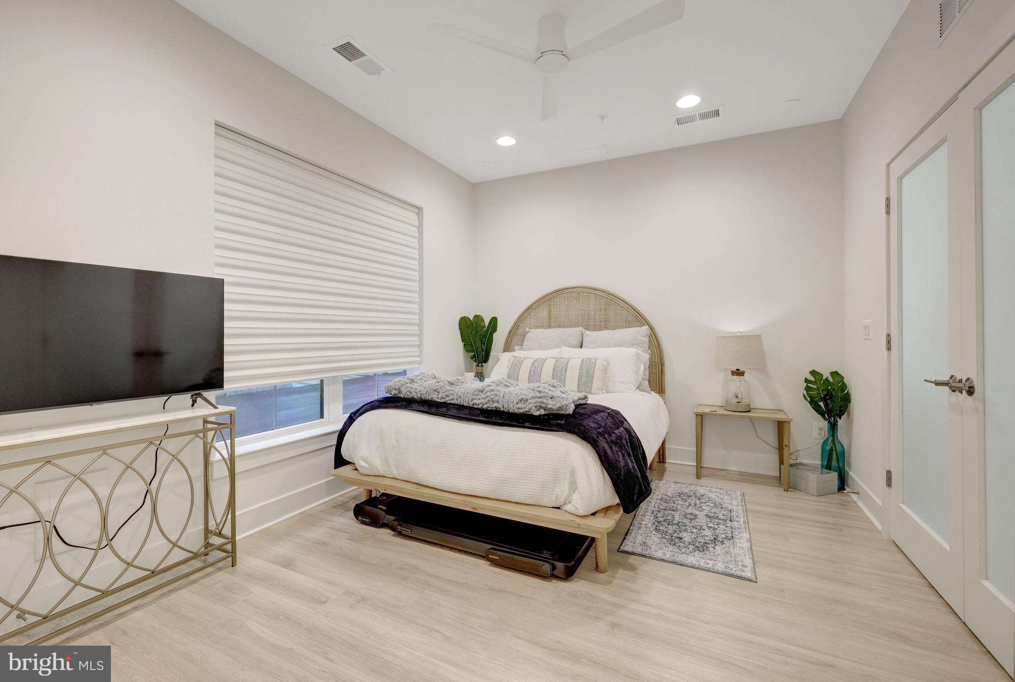 11236 Faraday Park Drive Reston, VA 20190 - Photo 7 of 74 a bedroom with a bed and flat screen tv