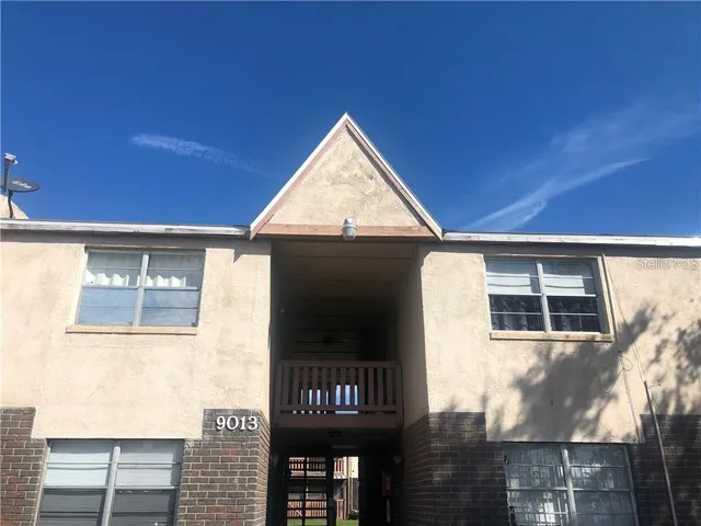 a kitchen with a refrigerator sink and cabinets