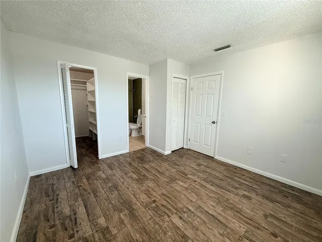 a view of walk in closet with wooden floor