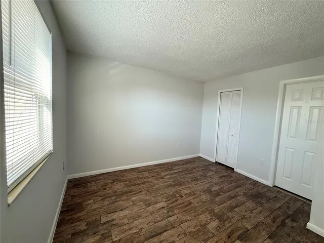 a view of a room with wooden floor and window