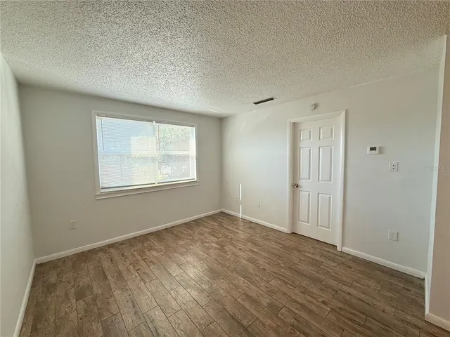 a kitchen with a refrigerator sink and cabinets
