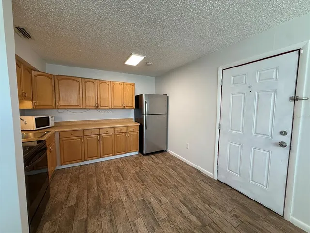 a kitchen with a refrigerator and a sink