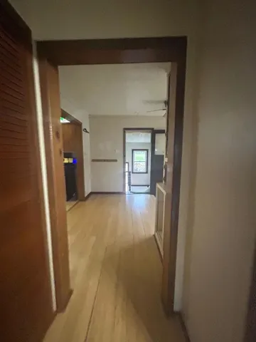 a view of empty room with wooden floor