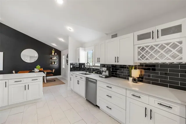 a bathroom with double vanity sinks and a mirror