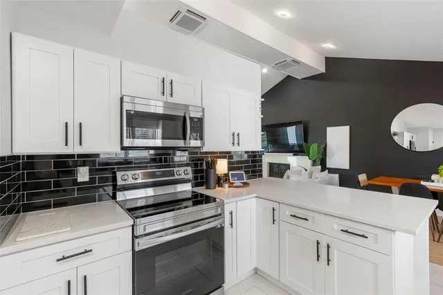 a bathroom with a shower sink mirror and toilet