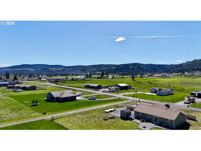 a backyard of a house with a yard and outdoor seating