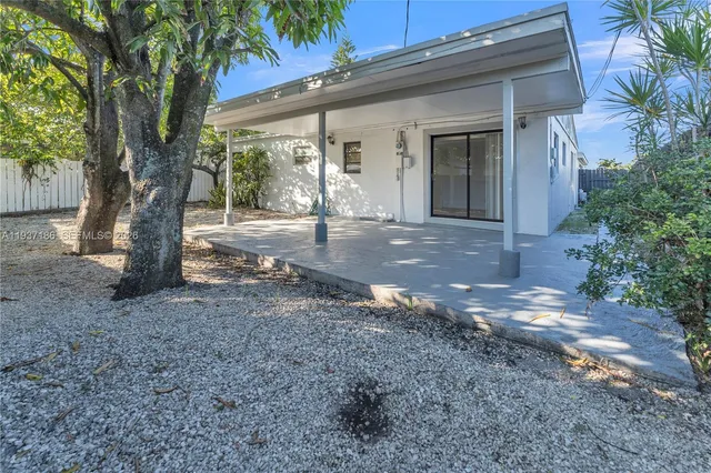 a view of a house with a tree in the yard