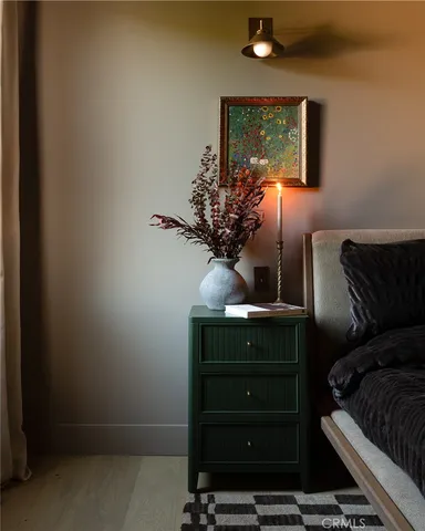 a bed sitting in a bedroom next to a window