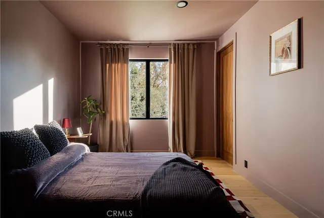 a bedroom with a bed and window