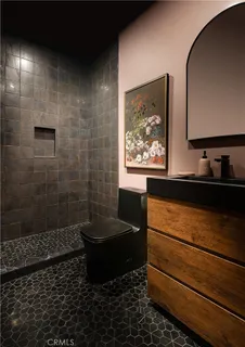 a bathroom with a sink vanity and a mirror