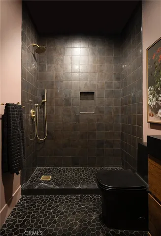 a bathroom with a double vanity sink mirror and toilet