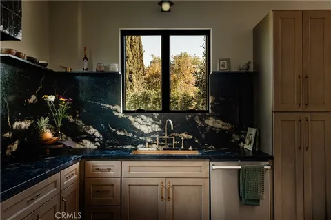 a kitchen with a sink stove and microwave